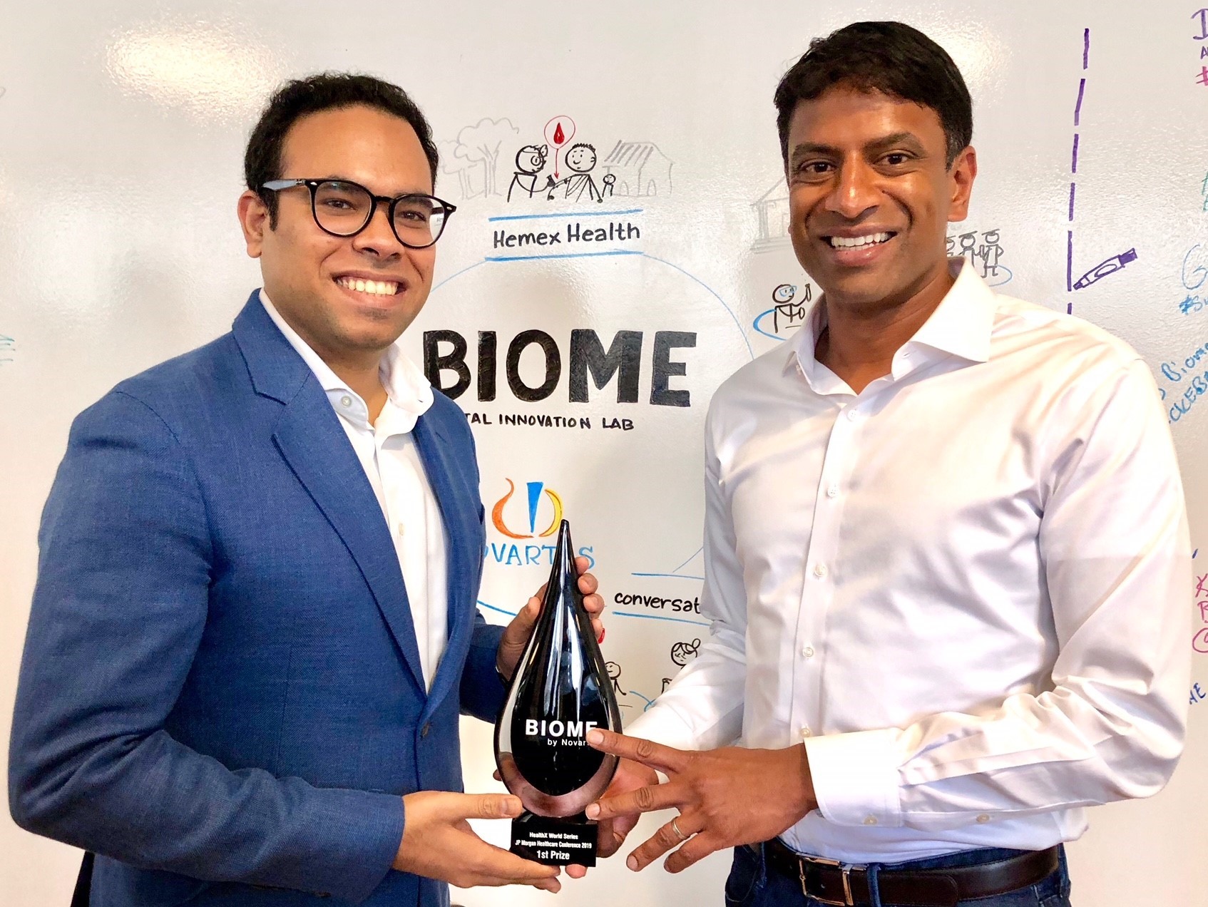 AIDAR Health founder receiving the Biome HealthX World Series first-prize trophy from the Novartis chief executive.